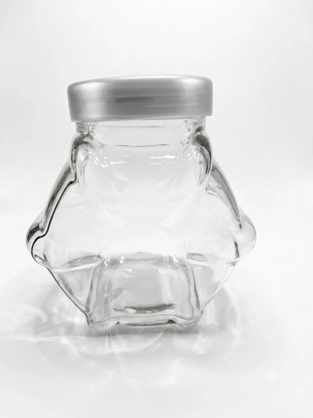 Ikea Förvar glass canister featuring a distinctive hexagonal shape & a gray lid.